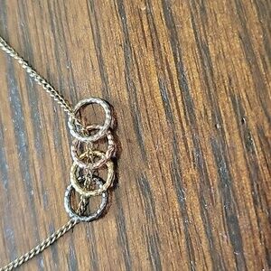 Very unique costume necklace - charms are white, rose, yellow, & black gold - K